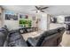Open-concept living room with kitchen view, tile floors, a ceiling fan, and comfortable seating at 2535 Georgia Ave, Sanford, FL 32773