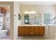Bright bathroom features double sinks, a walk in shower, and a separate toilet room at 271 Falling Waters Dr, Kissimmee, FL 34759