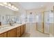 Bright bathroom features double sinks, a walk in shower, and a relaxing spa tub at 271 Falling Waters Dr, Kissimmee, FL 34759