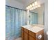 This bathroom features a large mirror, cabinets for storage and a shower/tub combo at 271 Falling Waters Dr, Kissimmee, FL 34759