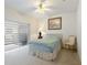 Cozy bedroom with a ceiling fan, carpet, and sliding door to balcony at 271 Falling Waters Dr, Kissimmee, FL 34759