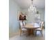 Elegant dining room with tile floors, chandelier, and views of the living area at 271 Falling Waters Dr, Kissimmee, FL 34759