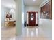 Inviting entryway with tile flooring, chandelier and views of formal dining area at 271 Falling Waters Dr, Kissimmee, FL 34759