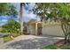 Street view of single-story home with attached two-car garage, front courtyard and neutral color scheme at 271 Falling Waters Dr, Kissimmee, FL 34759