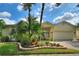 Inviting single-story home featuring a paver driveway, manicured landscaping, and a charming gated courtyard at 271 Falling Waters Dr, Kissimmee, FL 34759