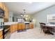 Bright eat-in kitchen featuring stainless steel appliances, wood cabinets, and tile flooring at 271 Falling Waters Dr, Kissimmee, FL 34759