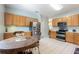 Bright kitchen featuring a wooden table set, stainless steel appliances, and tile flooring at 271 Falling Waters Dr, Kissimmee, FL 34759