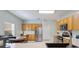 Bright eat-in kitchen featuring stainless steel appliances, wood cabinets, and tile flooring at 271 Falling Waters Dr, Kissimmee, FL 34759