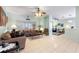 Comfortable living room featuring tile floors, a ceiling fan, and natural light at 271 Falling Waters Dr, Kissimmee, FL 34759