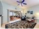 Inviting living room with plush seating, fan, and sliding glass doors to a sunroom at 271 Falling Waters Dr, Kissimmee, FL 34759