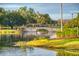 Scenic view of a stone bridge over a tranquil pond surrounded by lush landscaping at 271 Falling Waters Dr, Kissimmee, FL 34759