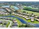 Beautiful aerial view of a waterfront community with golf course, lakes, lush landscaping and tiled roofs at 2724 Palm Tree Dr, Poinciana, FL 34759