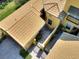 Birds-eye view of the tiled roof, private courtyard, and exterior architecture of this lovely home at 2724 Palm Tree Dr, Poinciana, FL 34759