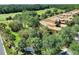 Aerial view showcasing a yellow-toned villa community nestled among lush greenery and manicured landscaping at 2724 Palm Tree Dr, Poinciana, FL 34759