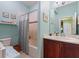 Cozy bathroom with a tub-shower combination and a light blue color scheme at 2724 Palm Tree Dr, Poinciana, FL 34759