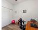 Functional bedroom featuring an office setup with chair, desk, and closet at 2724 Palm Tree Dr, Poinciana, FL 34759