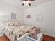 Cozy bedroom with a tropical-patterned bedspread and decorative pillows and accents at 2724 Palm Tree Dr, Poinciana, FL 34759