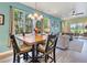 Open-concept dining room with wood table, backyard views and a seamless flow to the living area at 2724 Palm Tree Dr, Poinciana, FL 34759