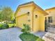Attractive curb appeal with two-car garage, lovely landscaping and inviting entry gate at 2724 Palm Tree Dr, Poinciana, FL 34759