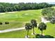 Scenic golf course view with manicured greens, sand traps and lush landscaping, a golfer's dream at 2724 Palm Tree Dr, Poinciana, FL 34759