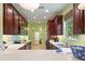 Bright kitchen boasting quartz countertops, stainless steel appliances, and wooden cabinetry throughout the entire space at 2724 Palm Tree Dr, Poinciana, FL 34759