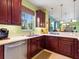 The kitchen features stainless steel appliances, wooden cabinets, and quartz countertops with a seamless design at 2724 Palm Tree Dr, Poinciana, FL 34759