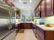 Modern kitchen with stainless steel appliances, wooden cabinets, and a spacious layout for easy cooking at 2724 Palm Tree Dr, Poinciana, FL 34759