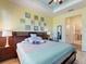 Comfortable bedroom featuring a king-size bed, ample natural light, and a connecting doorway to the ensuite bathroom at 2724 Palm Tree Dr, Poinciana, FL 34759