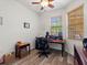 Bright office space with wood floors, dual windows, and stylish wooden desk at 2724 Palm Tree Dr, Poinciana, FL 34759