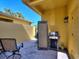 Outdoor patio area with a grill, privacy screen, and comfortable seating for relaxing and entertaining at 2724 Palm Tree Dr, Poinciana, FL 34759