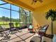 Enclosed patio offering scenic views, tiled floors, and ample seating for relaxation in the beautiful outdoors at 2724 Palm Tree Dr, Poinciana, FL 34759