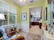 Bright sitting area with large windows offering natural light and views to the connected kitchen at 2724 Palm Tree Dr, Poinciana, FL 34759
