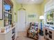 Sunroom features rattan chair and large windows at 2724 Palm Tree Dr, Poinciana, FL 34759