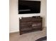 Bedroom features a wooden dresser and a wall-mounted television at 3041 Tobago Dr, Haines City, FL 33844