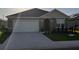 Charming single-story home with a two-car garage and well-maintained landscaping at 3041 Tobago Dr, Haines City, FL 33844
