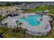 Aerial view of a community pool with chairs, palm trees, and a gazebo at 3041 Tobago Dr, Haines City, FL 33844