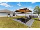 Spacious backyard featuring outdoor seating arrangements and above ground pool at 3111 Turnberry Blvd, Kissimmee, FL 34744