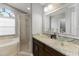 Well-lit bathroom featuring dual glass vessel sinks and a separate shower and tub at 3111 Turnberry Blvd, Kissimmee, FL 34744