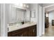 Bathroom vanity with granite counters and dual glass vessel sinks beneath a large mirror at 3111 Turnberry Blvd, Kissimmee, FL 34744