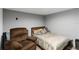 Cozy basement bedroom with a recliner and comfortable bedding at 3111 Turnberry Blvd, Kissimmee, FL 34744