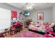 Bright bedroom with a pink theme, decorations, and tile flooring at 3111 Turnberry Blvd, Kissimmee, FL 34744