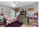 bedroom with gray walls, ceiling fan, and decorative Minnie Mouse accents at 3111 Turnberry Blvd, Kissimmee, FL 34744