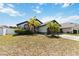 Charming home exterior with a well-manicured lawn and beautiful landscaping and a two car garage at 3111 Turnberry Blvd, Kissimmee, FL 34744
