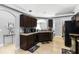 Open kitchen design with a sink, tiled floor, and brown cabinetry at 3111 Turnberry Blvd, Kissimmee, FL 34744
