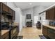 Kitchen area with tile flooring, dark cabinets, and dining decor at 3111 Turnberry Blvd, Kissimmee, FL 34744
