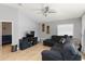 Comfortable living room featuring tile flooring, gray walls, a ceiling fan and a dark colored sofa at 3111 Turnberry Blvd, Kissimmee, FL 34744