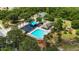 Overhead view of pool with clubhouse, playground, tennis court, and green space at 3111 Turnberry Blvd, Kissimmee, FL 34744