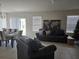 Open-concept living room and dining room, featuring neutral colors and tile floors at 320 Aberdeen Dr, Davenport, FL 33896