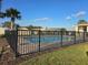 Community pool surrounded by black fencing and landscaping at 320 Aberdeen Dr, Davenport, FL 33896