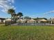 Community pool with lush landscaping and palm trees at 320 Aberdeen Dr, Davenport, FL 33896
